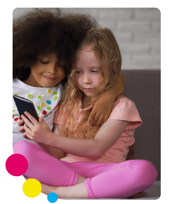 Two girls use a tablet together at home