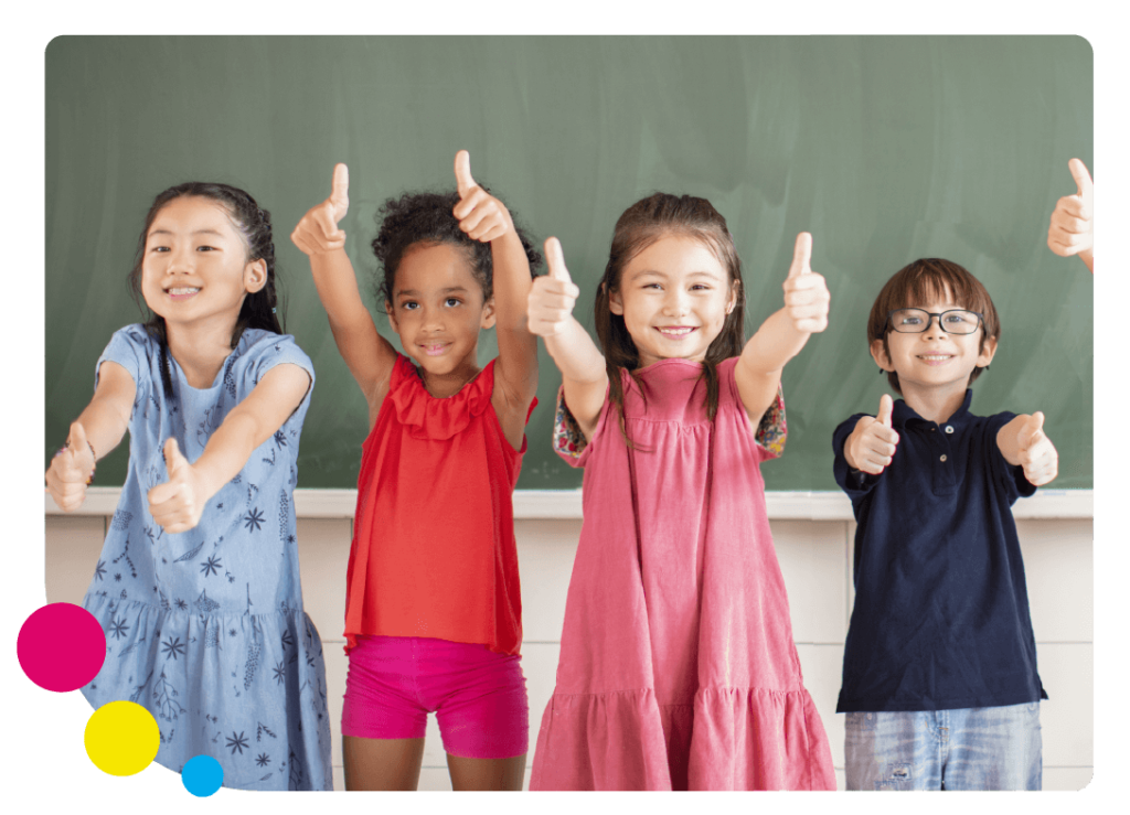A diverse group of students in bright clothing standing in front of a chalk board with their thumbs up with colourful circles